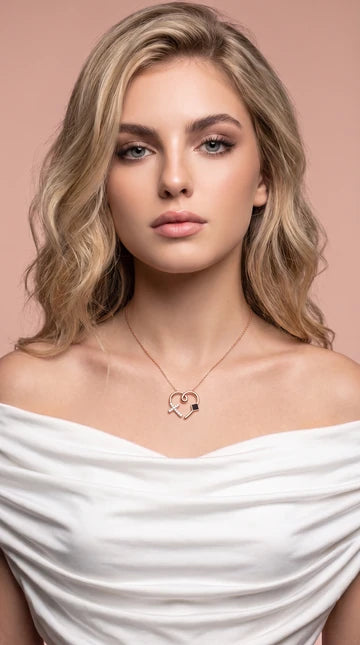 Nano Faith model photograph 1: a necklace styled with a white top against a blush background