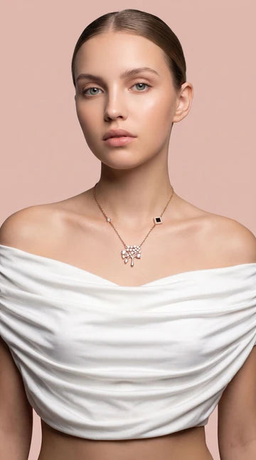 Nano Faith model photograph 3: a necklace styled with a white top against a blush background