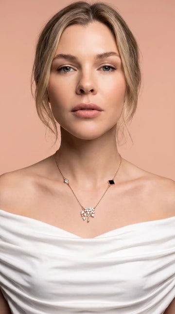 Nano Faith model photograph 4: a necklace styled with a white top against a blush background