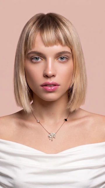 Nano Faith model photograph 5: a necklace styled with a white top against a blush background