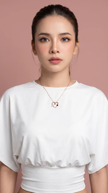 Nano Faith model photograph 6: a necklace styled with a white top against a blush background