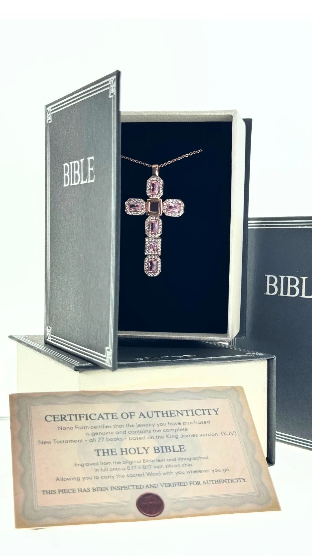 Pink cross necklace in a Bible-shaped Nano Faith presentation box with its certificate