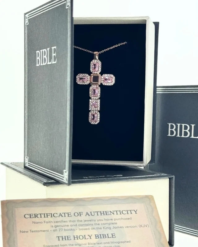 Pink cross necklace presented inside its Bible-shaped box