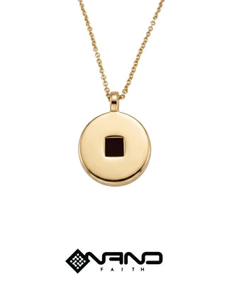 Round gold pendant with a tiny dark square inset